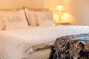 a bed with white sheets and pillows in a bedroom at Apartments Villa San Antonio in Slatine