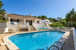 a villa with a swimming pool and a house at Villa Canela b11 in Santo Tomás