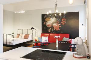 a living room with a table and a bedroom at Faust Apartments in the Heart of Kazimierz in Krakow