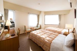 Voodi või voodid majutusasutuse Hotel Keifuku Fukui Ekimae toas