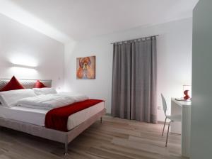 a bedroom with a bed and a desk and a table at B&B Perbacco Relax in Mezzolombardo