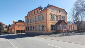 a large building on the side of a street at Bahnhotel Dippoldiswalde in Dippoldiswalde
