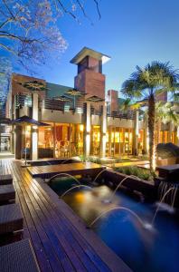 a hotel with a swimming pool in front of a building at Fusion Boutique Hotel in Polokwane