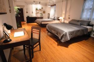 a bedroom with two beds and a table and a desk at City Hostel Da Nang in Danang +162 photos
