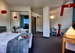 a hotel room with a bed and a table and chairs at Albornoz Palace Hotel in Spoleto +101 photos