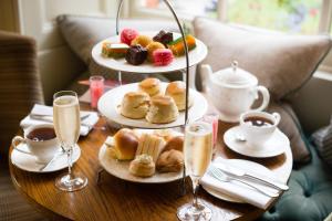 a table with three plates of pastries and glasses of champagne at Lainston House in Winchester