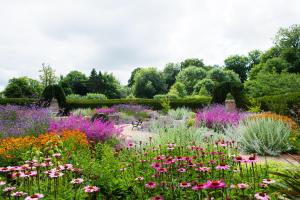 a garden with colorful flowers and bushes at Lainston House in Winchester