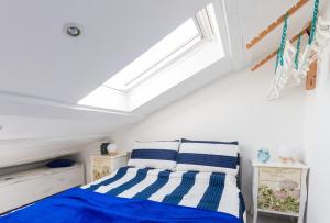 a bedroom with a bed and a skylight at Blue Sea Apartment by Locap Group in Piran
