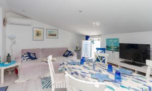 a living room with a table and a couch at Blue Sea Apartment by Locap Group in Piran