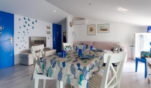 a dining room with a table and chairs and a bedroom at Blue Sea Apartment by Locap Group in Piran