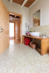 a bathroom with a sink and a mirror at Cascina Serenella - Casa Vacanze in Calcinato