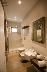 a bathroom with a sink and a toilet and a shower at Porto Cesareo Exclusive Room in Porto Cesareo