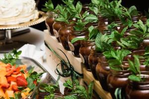 a table topped with jars filled with plants and fruit at B&B Perbacco Relax in Mezzolombardo