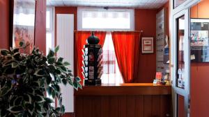 a room with a window with red curtains at Hotel Le Lumière in Lyon