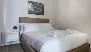 a bedroom with a bed with towels on it at Italianway-Cadorna 10A Flat in Milan