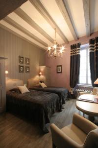 Säng eller sängar i ett rum på Hôtel St Pierre