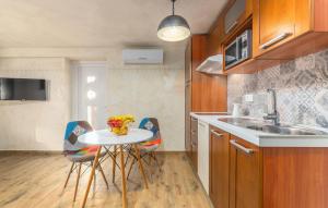 a kitchen with a table and chairs and a sink at Villa Stephany in Poreč