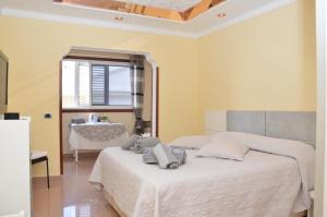 a bedroom with two beds and a table and a window at B&B Paraiso del Sol in Maspalomas