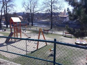 a playground in a park next to a river at Apartmán Aromasalon in Třebíč