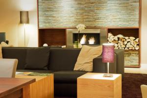 a living room with a couch and a fireplace at Strandhotel Binz in Binz