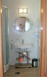 a bathroom with a sink and a mirror at Vila Vuk in Plitvička Jezera