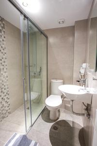 La salle de bains est pourvue de toilettes, d'un lavabo et d'une douche. dans l'établissement Emilia Hotel Apartments, à Réthymnon