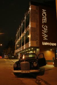 an old car parked in front of a building at Hotel Samm Bistro Spa in Ankara