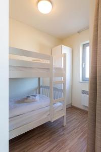 
a bedroom with a bunk bed and a window at Aparthotel Blankenberge in Blankenberge
