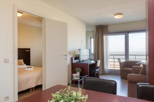 a hotel room with a bed and a room with a view at Aparthotel Blankenberge in Blankenberge