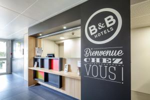 a sign for a bmw store in a lobby at B&B HOTEL Corbeil-Essonnes in Corbeil-Essonnes