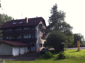 Hotel Bacchusstube garni في Goldbach: منزل كبير فيه سيارة متوقفة أمامه