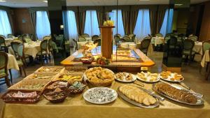 a table with many different types of food on it at Hotel Pian Nava in Premeno