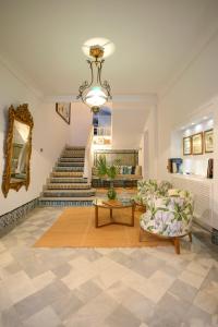 a living room with a staircase and a chandelier at Dar Marsa Cubes in La Marsa