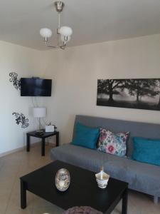 a living room with a couch and a table at Themis Apartments in Sami