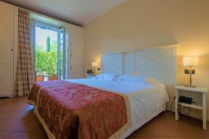 a hotel room with a large bed and a large window at Hotel Villa Cappugi in Pistoia