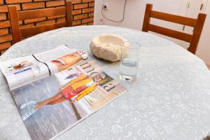 a table with a magazine and a glass of water at Apartments Ivo Bozinovic in Tivat