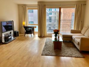 a living room with a couch and a tv at Luxury Apartments in Westminster in London