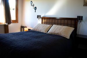 Cama ou camas em um quarto em Cabañas Normana Inn