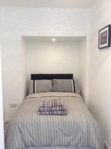 a bed with two pillows on it in a bedroom at Rooftop Apartments in Belfast