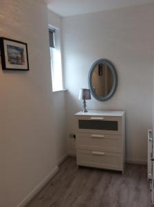 a dressing room with a mirror and a dresser at Rooftop Apartments in Belfast