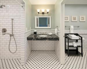 a white bathroom with a sink and a shower at Lavender Inn by the Sea in Santa Barbara
