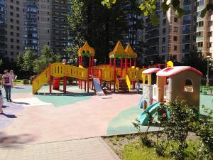 a playground in a park with a slide at Apartment na Fermskom Shosse 32 in Saint Petersburg