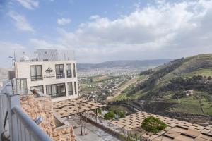 a building on a hill with a view of a city at Sindyan Resort in Amman