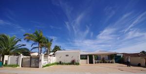 a house with a fence and a palm tree at Astoria Retreat Bed & Breakfast in Perth