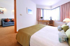 A bed or beds in a room at The Kimberley Hotel