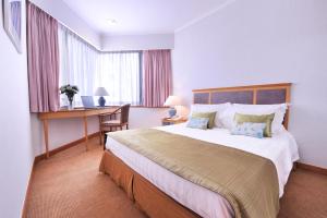 A bed or beds in a room at The Kimberley Hotel