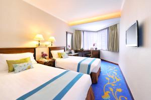 A bed or beds in a room at The Kimberley Hotel