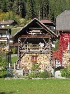 a stone house with a window on the side of it at Pension Haus Edelweiss in Weissensee