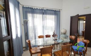 a dining room with a glass table and chairs at Hotel Al Ritrovo in Castelluzzo