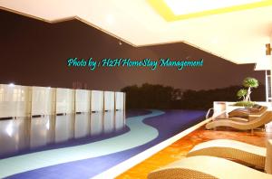 a lobby with chairs and a swimming pool at H2H - London House @ Majestic Ipoh (8~10 Guests) in Ipoh